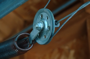 Go to the pulley by the extension spring.