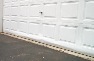 Bent garage door. Damaged from fall with broken spring
