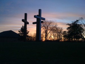 An image of three crosses with a sunset in the background indicating the resurrection.