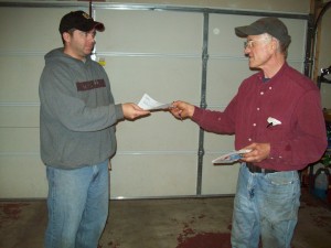 A satisfied DDM Garage Doors, Inc. customer receiving his receipt for the purchase of garage door springs.