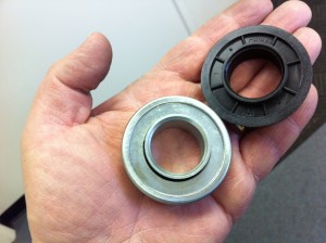 An image of a standard bearing and a nylon bushing used when installing garage door springs.