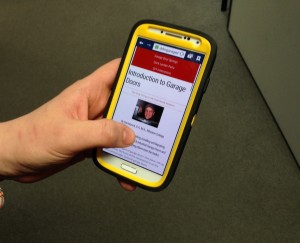 A view of a smartphone accessing the DDM Garage Doors website. 