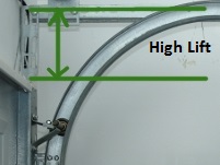 Green arrows indicating were the high lift is located on the garage door tracks.