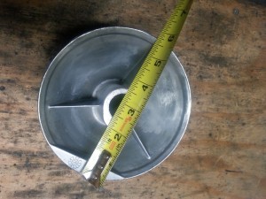 A tape measure showing that the diameter of a standard high lift drum is approximately 5 3/4 inches.