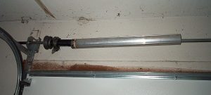 An image of an Overhead Door ARMOR-TITE system with the spring covered by an aluminum tube.