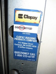 A blue Clopay sticker showing the model number 1000.