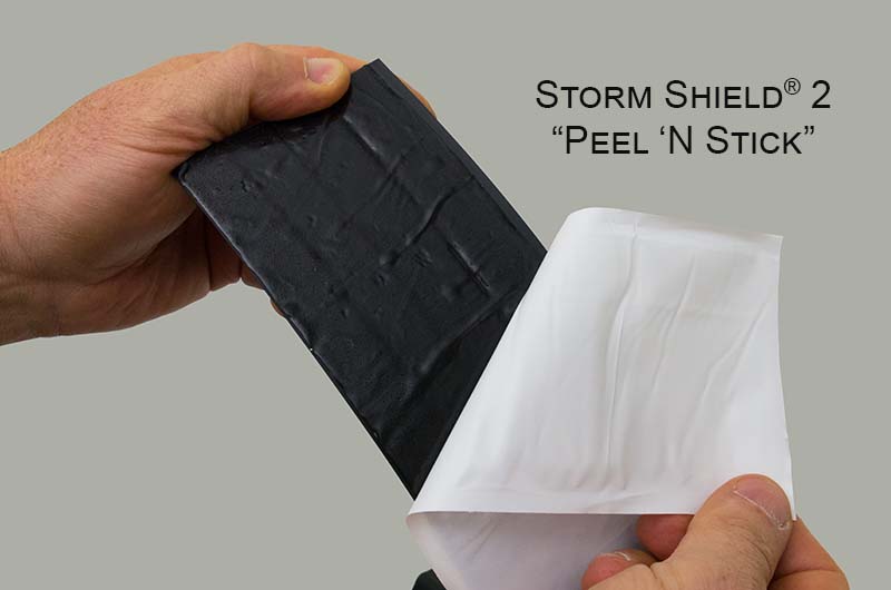 The Storm Shield® 2 threshold seal with the plastic being pulled away relieving the adhesive backing.