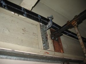 An angle iron supporting the spring anchor bracket. 