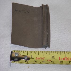 An obsolete garage door seal that is 1 3/4 inches in height and brown in color.