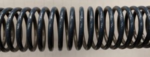 A view of a garage door spring coils being separated.
