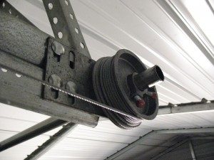 A view of a garage door cable that comes off the bottom of the drum.