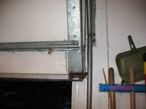 A frayed garage door cable near the bottom of the door.