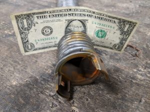 A one-dollar bill placed in between the gaps of an EZ-SET Torsion Spring.
