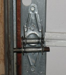 Image of a broken 18 gauge hinge on a garage door.