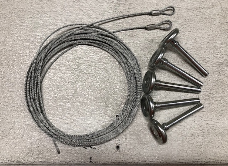 Image of cable assembled with open loop and garage door rollers. This are garage door parts that are replaced with the use of tools for garage door repair.