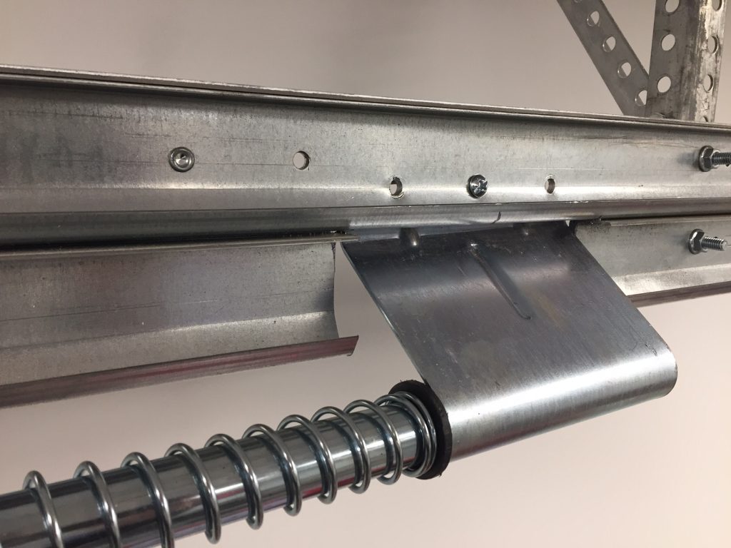 A closeup view of the track mounting with lower track cut by a grinder.                                                                                                                                                                                                                                                                                                                          