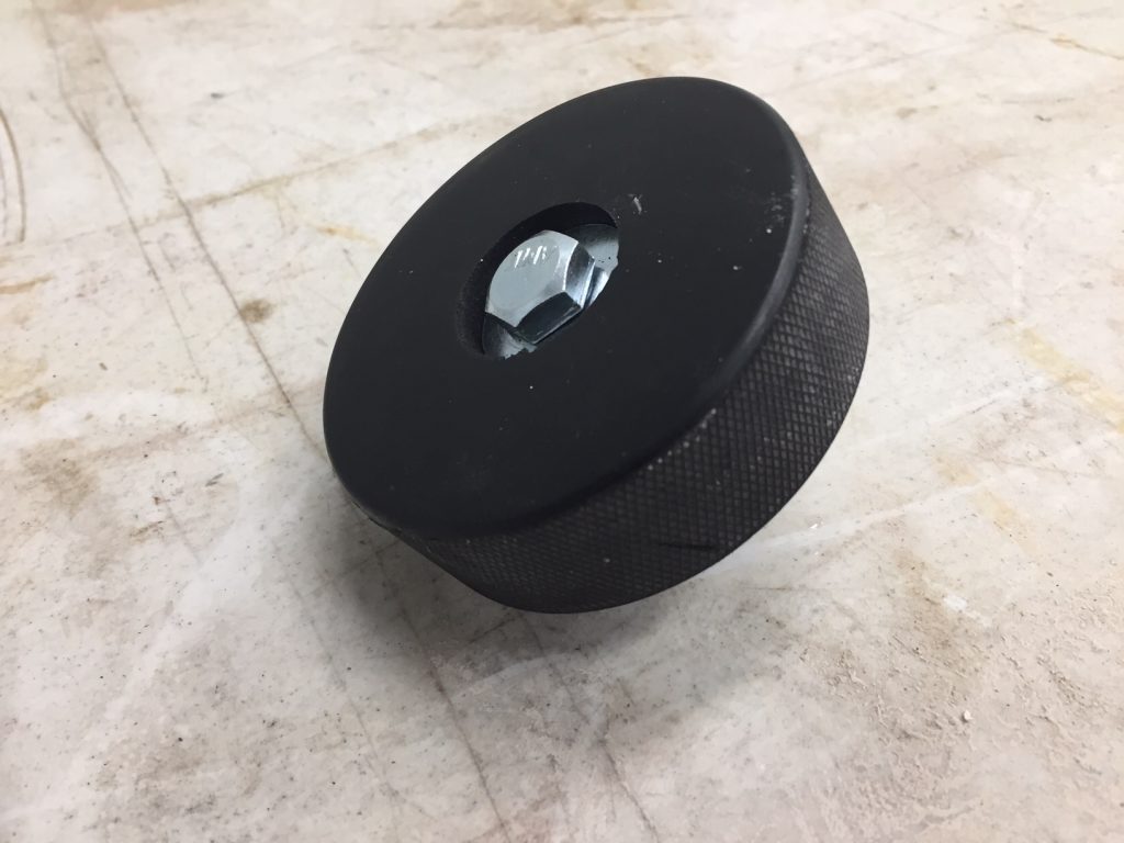 An image of a hockey puck from Play it Again Sports that is used as a bumper.
