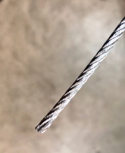 An image of a raw garage door cable.