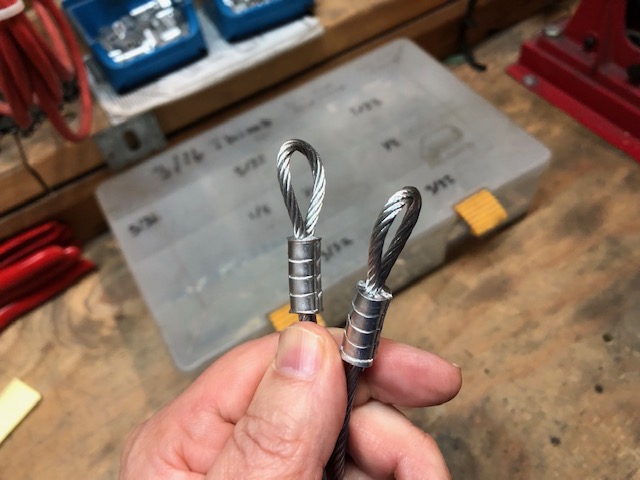 A view of round cable tops on the tops of a garage door cable. 