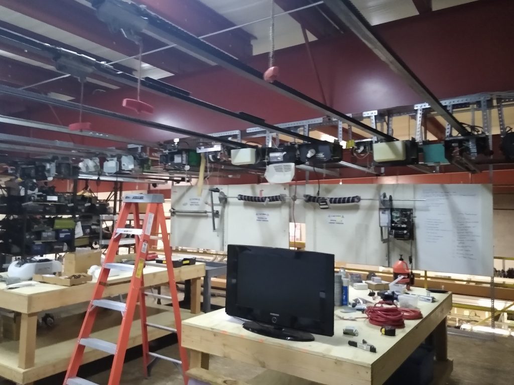 A view of the training facility for servicemen that repair garage doors. Displayed is a wide assortment of springs.