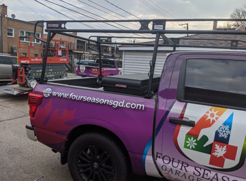 A picture of a Four Seasons Garage Door pick-up truck showing the Four Seasons logo and website.