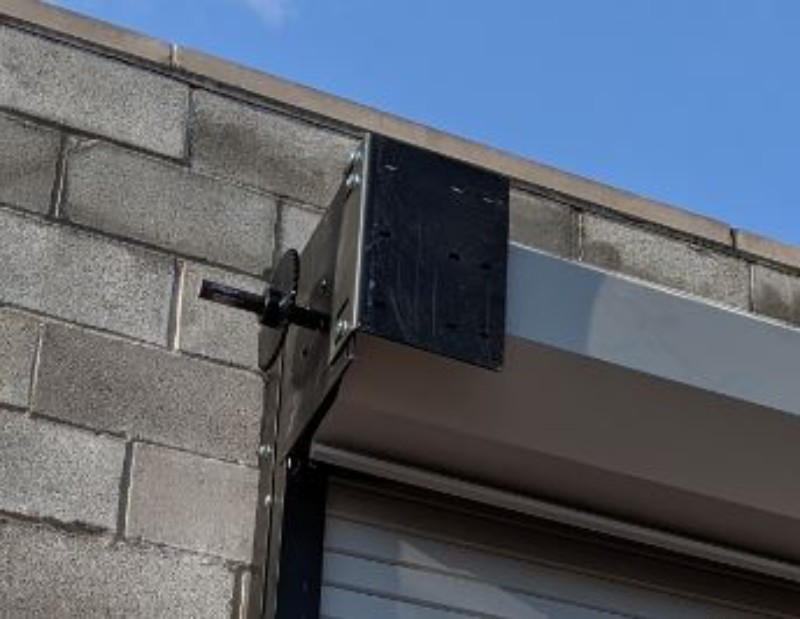 An installation showing a steel rolling door mounting bracket on the drive side of the door.