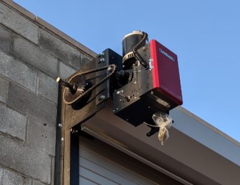 An image showing a Commercial Door Operator installed on a steel rolling door.