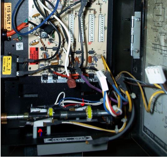 An image of the inside of a LiftMaster operator showing the limit nuts and switches.