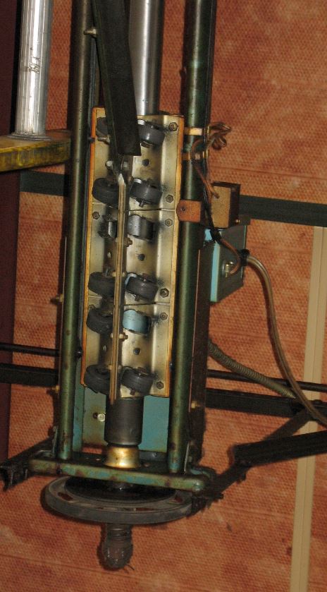 An older Scientific operator using track-mounted switches to stop the door.