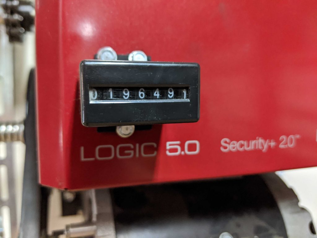 An image of  a LiftMaster operator with an external counter showing 196,491 cycles. 