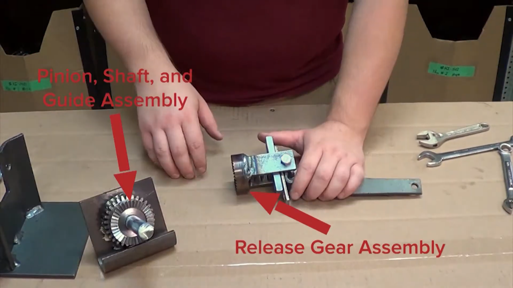 Separating the release gear assembly from the pinion, shaft, and guide assembly