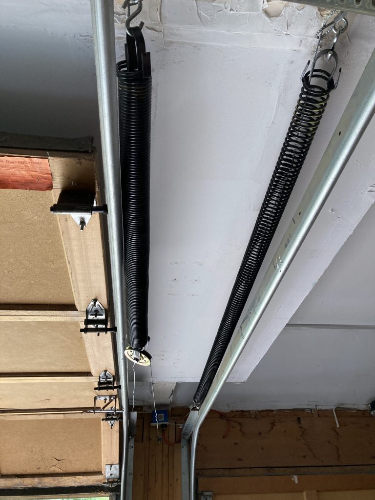 Two long-life extension springs, one with the door open and the other with it closed