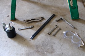 Gather the supplies and tools needed to replace garage door torsion springs.