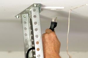 Unplug power to garage door opener to safely replace torsion springs.