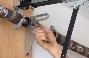 Secure garage door shaft to spring anchor bracket.