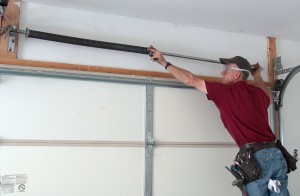 Slide torsion springs to center above garage door.