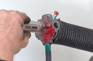 Mark shaft for stretching garage door torsion springs.