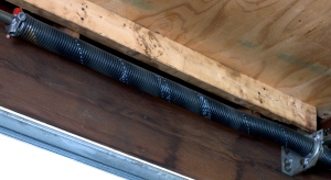 An image of an installed garage door torsion spring.