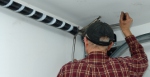 Garage door repair: Winding new torsion springs.